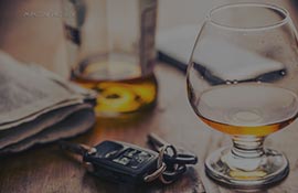 Car keys and a glass of alcohol